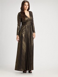 Shimmering, floor-length v-neck with a ruched silhouette and flattering empire waist. Gathered v-neckRuched empire waistLong sleevesInvisible back zipperAbout 65 from shoulder to hemFully lined92% polyester/8% spandexDry cleanMade in USA of imported fabric