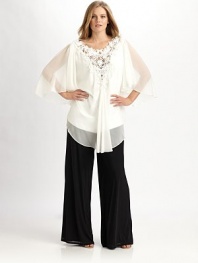 An airy design with pretty flutter sleeves and an incredible beaded-lace neckline. V-neckThree-quarter sleevesBack zipperAbout 33 from shoulder to hemFully linedPolyesterDry cleanImported