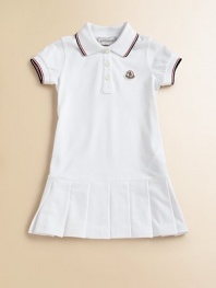 Soft, airy pique knit with sporty stripes, perfect for your future tennis star.Ribbed polo collar with two-color striped tippingShort sleeves with ribbed, tipped cuffsButton placketLogo appliqué at chestDropped waist with box pleated skirt96% cotton/4% elastaneMachine washImported Please note: Number of buttons may vary depending on size ordered. 