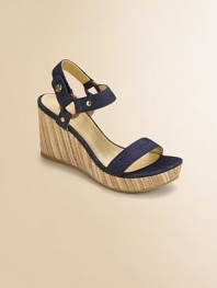 Two favorites combined - denim straps atop a raffia covered wedge.Cotton-blend denim upperAnkle strap with ring and snap closeRaffia-covered wedge heel with rubber soleFaux leather liningImported
