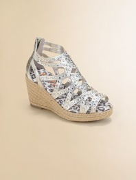 Lustrous metallic fabric in a graphic cutout pattern is sprinkled with sparkling rhinestones and sits atop a rope-covered wedge.Metallic microsuede fabric upperRhinestone accentsBack zipper for easy on and offRope-covered wedgePadded insoleComposite rubber solePrint faux leather liningImported