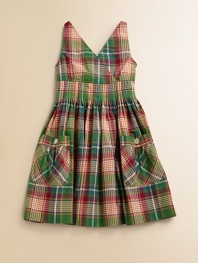 This fun sundress is crafted in preppy madras plaid with pintuck detailing and large patch pockets.V-neckSleeveless cross-front bodiceHidden side zipper with hook-and-eye closureWaist with pintuck detailingLarge patch pockets with button closureFull skirtCottonMachine washImported
