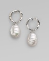 Distinctive white baroque pearls dangle delightfully from hammered sterling silver hoops. 12mm white baroque organic man-made pearls Sterling silver Hoop diameter, about ½ Post back Made in Spain