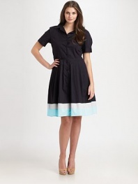 A classic stretch cotton style with a flared skirt featuring a colorblocked hem.Collar styleButton frontCuffed short sleevesAbout 51 from shoulder to hem97% cotton/3% spandexDry cleanMade in USA of imported fabric