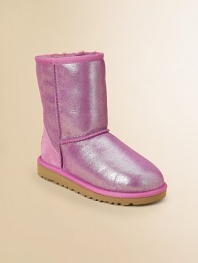 Glitter adorns this update on the original Ugg design, in sheepskin to keep feet warm, dry and in style all season long.Pull-on styleSheepskin upperSheepskin liningMolded EVA sole is light and flexiblePadded insoleImported