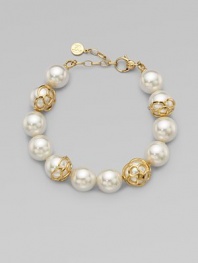 An exquisite strand of pearls accented with 18k gold flower cup caps.14mm round white organic man-made pearls18k goldplated sterling silverLength, about 7½ Lobster clasp closureImported 