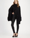 Exquisitely crafted merino wool with cascading ruffles, poncho sleeves and a flowing, feminine silhouette. Tiered ruffle collarHook-and-eye closures at collarRuffled open frontLong poncho sleevesTiered ruffle hemMerino woolDry cleanImported