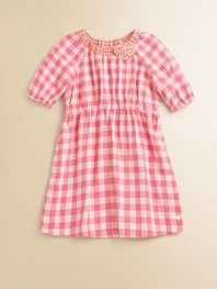 Rendered in pure cotton, this soft and sweet gingham print frock is perfect for school, play or a party.Ruched crewneck with bowShort puffed sleeves with elastic cuffsElastic waistShirttail hemCottonMachine washImported