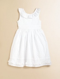 Pretty eyelet in an angelic hue with ruffles create a sweet and innocent appeal.Ruffled jewelneckSleevelessBack buttonsWaist has back tieFull skirtCottonMachine washImported Please note: Number of buttons may vary depending on size ordered. 