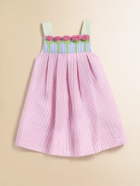 This beautiful seersucker frock is adorned with pastel-hued stripes and a row of pretty tulips.Square neckline with rosettesWide strapsBack zipperPleated empire waist55% cotton/45% polyesterMachine washImported