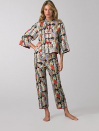 Asian-inspired pajamas look and feel like silk, yet are easily washable. Mandarin collared top Contrast button-and-loop closures Wide three-quarter sleeves with slit cuffs Side slits at hem Full length pant with drawstring waist Piped slit cuffs Polyester; machine wash Imported
