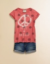 A cute graphic tee with big polka dots and a peace sign give it a fun, girlie feel.ScoopneckShort sleeves with rolled cuffsPatch on left sleeveGraphic print on front and backStitched hemCottonMachine washImported