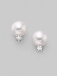 From the Akoya Collection. Classic white cultured pearl studs with sparkling diamond accents, set in 18k gold. 7mm white round cultured pearls Quality: A+ Diamonds, 0.10 tcw 18k white gold Post back Imported