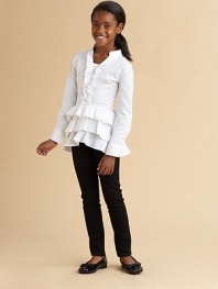 Airy tiers of ruffles skirt the hem of this blousy woven tunic.Band collar Ruffled neck and hem Banded button cuffs Back zip 98% cotton/2% spandex Machine wash Imported