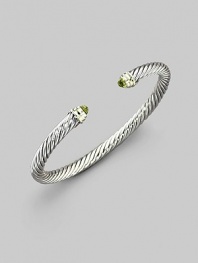 From the Color Classics Collection. The signature Yurman cable, in a graceful bangle capped with faceted peridot domes and accents of 14k gold. Peridot Sterling silver and 14k yellow gold Cable, 5mm Diameter, about 2¼ Imported