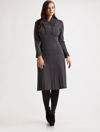 This pretty style featured a ruffled, pleated v-neck and pleated cuffs. Ruffled, pleated v-neck Long sleeves with pleated cuffs Pull-on style Wool Dry clean Made in Italy 