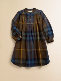 Deeply colored, large-scale checks from Italy in an easy, shirt-style silhouette that's all Burberry and all adorable.Banded neckline with button-and-loop closureLong sleeves with button cuffsBib front with buttonsFront and back yokes with soft pleatingTwo slash pocketsU-shaped hem50% cotton/50% woolHand washImported Please note: Number of buttons may vary depending on size ordered. 