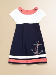 Set sail for this gorgeous, sailor-inspired frock in a classic a-line silhouette with anchor appliqué.Boatneck with button detailShort sleevesBack buttonsA-lineStriped hemCottonMachine washImported Please note: Number of buttons may vary depending on size ordered. 