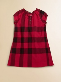 A sweet and simple little frock in a large-scale, deep-toned check.Round neckline with tiny ruffle and soft gatheringShort, puff raglan sleeves with banded cuffsButton placketSlightly flared shapeCottonMachine washImported Please note: Number of buttons may vary depending on size ordered. 