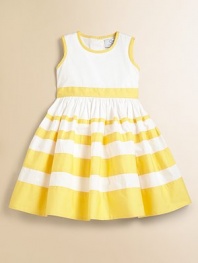 Sunny stripes on crisp cotton gradually get wider as the pretty skirt gets fuller.Round neckline with contrast bandSleevelessFitted bodiceContrast waistband ties in backBack buttonsFull skirtCotton liningCottonMachine washImported Please note: Number of buttons may vary depending on size ordered. 