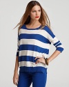A versatile, relaxed fit DKNY striped cotton sweater is lightweight and perfect for layering throughout the seasons.