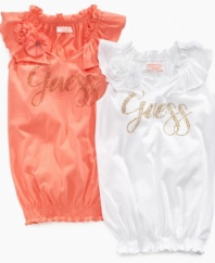 Feeling fancy. Dress up her casual wardrobe with this rhinestud accented, flounce-neck shirt from Guess.