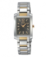 As indispensable as a pair of pearl earrings, this Seiko watch is the classic everyday watch. Two-tone stainless steel bracelet and rectangular case. Charcoal dial with striped inner dial features goldtone numeral at twelve o'clock, stick indices, two hands and logo. Quartz movement. Water resistant to 30 meters. Three-year limited warranty.