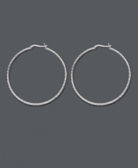 Chic, versatile style with a designer edge. Traditional hoop earrings feature an intricate diamond-cut pattern. Crafted in sterling silver. Approximate diameter: 2 inches.