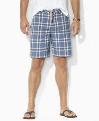 A handsome plaid pattern lends preppy heritage to a classic-fitting swim trunk, rendered in a quick-drying cotton-nylon blend for a sleek finish.