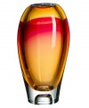 Like a blazing sunset over the tropics, this Vision vase from Kosta Boda brightens a room in an eye-catching combination of amber and pink. Luxuriously crafted art glass flows in a smooth, elliptical shape to emphasize the striking palette.