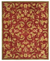 Bold burgundy houses an intricate assortment of intertwined blossoms and vines on this Turkish-inspired area rug from Safavieh. Pure wool is hand-tufted in a thick three-quarter-inch pile, finished with a cotton backing for long-lasting durability.