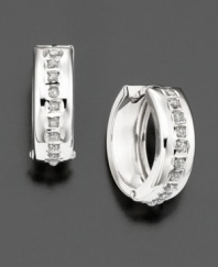 Diamond accents are set within wide, gleaming hoops of 14k white gold.