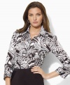 Crisply tailored from smooth cotton sateen with chic three-quarter sleeves, this classic petite Lauren by Ralph Lauren shirt gets a bold update with a bright and breezy paisley print. (Clearance)