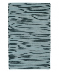 Presenting a new wave in fashionable home decor, this fluid area rug is streaked with black lines across a shimmering ocean-blue ground. Crafted from dense wool pile, the Artist Studio rug offers a uniquely textured feel that is incredibly soft to the touch.