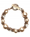 Flex your fab fashion sense. Givenchy's dazzling bracelet combines glass pearls and crystals in a unique brown gold-plated mixed metal setting. Bracelet features a toggle clasp closure. Approximate length: 7-1/2 inches.