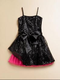 Full of frill, this notice-me frock shines like a disco ball covered in sequins and then finished off with a full, peekaboo hem.Straight necklineSleeveless with spaghetti strapsBack zipperWaistband with sash tieFull skirt with peekaboo hemPolyesterDry cleanMade in the USA of imported fabric