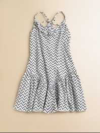Crafted with a trendy zig-zag print, this lightweight cotton frock in a drop-waist silhouette with ruffled hem is all the rage.Ruffled round necklineSpaghetti strapsTie-backBack elasticDrop-waistRuffled, flared hemCottonMachine washImported