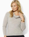The ultra-luxe cashmere sweater is tailored with a chic cowl neckline for modern, sophisticated style.