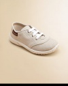 This cozy pair of neutral-hued canvas kicks for your little angel will mix and match with everything.Slip-onCanvas upperCanvas liningRubber solePadded insoleImported