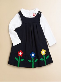 A beautiful, girly jumper/dress blooming with colorful floral appliqués and a pretty pleated bodice.SquareneckShoulder straps with button closureEmpire waistPleated bodice65% polyester/35% cottonMachine washImported Please note: Number of buttons may vary depending on size ordered. 