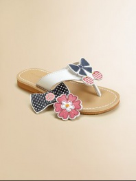 Choose a design to fit her mood: these adorable thong sandals come with three interchangeable grip-tape appliqués to complement her character or style for the day.Grip-tape appliqués include flowers, bow with cherries or bow with buttonsLeather upperPolyurethane liningPolyurethane soleImported