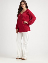 Flattering and feminine, this tunic features an elasticized neckline and cuffs. Its relaxed fit and unique chain detail will make this design one of your favorites.Self-tie v-necklineDolman sleevesGathered details at backPull-on styleAbout 30 from shoulder to hem95% polyester/5% spandexMachine washImported