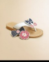 Choose a design to fit her mood: these adorable thong sandals come with three interchangeable grip-tape appliqués to complement her character or style for the day.Grip-tape appliqués include flowers, bow with cherries or bow with buttonsLeather upperPolyurethane liningPolyurethane soleImported