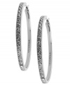Go big this season. T Tahari blends silver tones with shimmering crystal studs on these large hoop earrings. Crafted in silver tone mixed metal. Base metal is nickel-free for sensitive skin. Approximate diameter: 1-1/4 inch.
