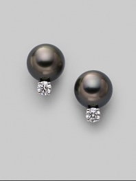 From the South Sea Collection. Classic black cultured pearl studs with sparkling diamond accents, set in 18k gold. 8mm black round cultured pearls Quality: A+ Diamonds, 0.20 tcw 18k white gold Post back Imported