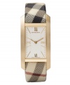 This Burberry watch features a Haymarket check fabric strap and rectangular gold ion-plated stainless steel case. White sunray dial with inner check-patterned dial featuers gold tone Roman numerals at twelve and six o'clock, stick indices, minute track, two hands and logo. Swiss made. Quartz movement. Water resistant to 30 meters. Two-year limited warranty.