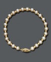 A polished pearl strand with a little extra shine. Bracelet features cultured freshwater pearls (5-1/2-6 mm) accented by shiny 14k gold beads and an ornate clasp. Approximate length: 7 inches.