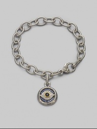 Bold, textured links of sterling silver hold a protective evil eye charm, radiantly created of white, blue and black sapphires with a touch of 18k gold. Sapphires Sterling silver and 18k yellow gold Bracelet length, about 7½ Charm diameter, about ¾ Heart-shaped lobster clasp Made in USA
