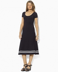 A timeless dress is rendered in a soft Pima cotton blend and finished with a flared skirt for a modern silhouette.