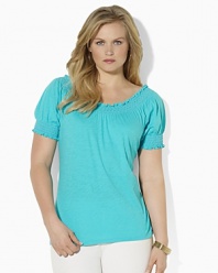 Imbued with breezy bohemian style, a soft cotton jersey top gets a romantic update with a smocked neckline and cuffs.